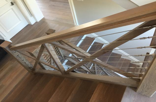 Weathered gray Custom Stair case with stainless steel cable.